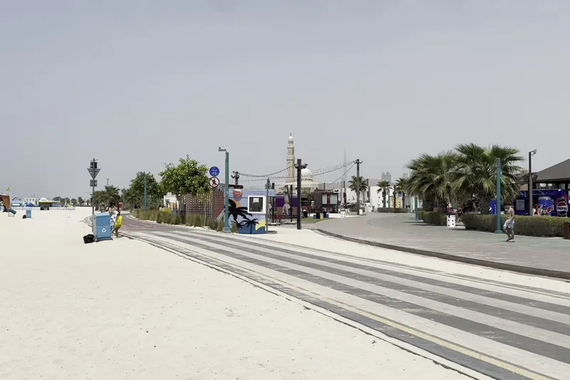 Пляж Kite Beach и прогулочная набережная с пальмами в Дубае