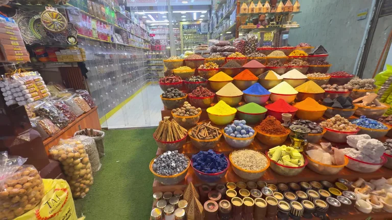 Традиционная лавка с коническими горками разноцветных специй, таких как куркума и паприка, расположенная на рынке.