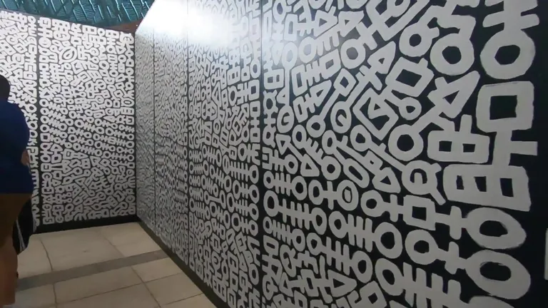 Hallway with black and white abstract patterns on the walls.