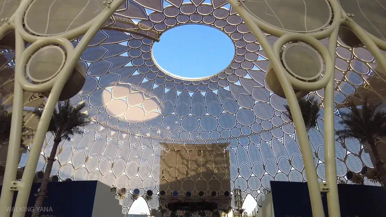 Looking up at the intricate trellis and sky through the oculus of Al Wasl Plaza.