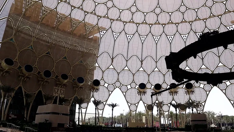 Intricate geometric lattice dome of Al Wasl Plaza from an interior perspective.