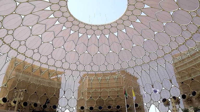 Direct view looking up at the center opening of the Al Wasl Plaza dome trellis.
