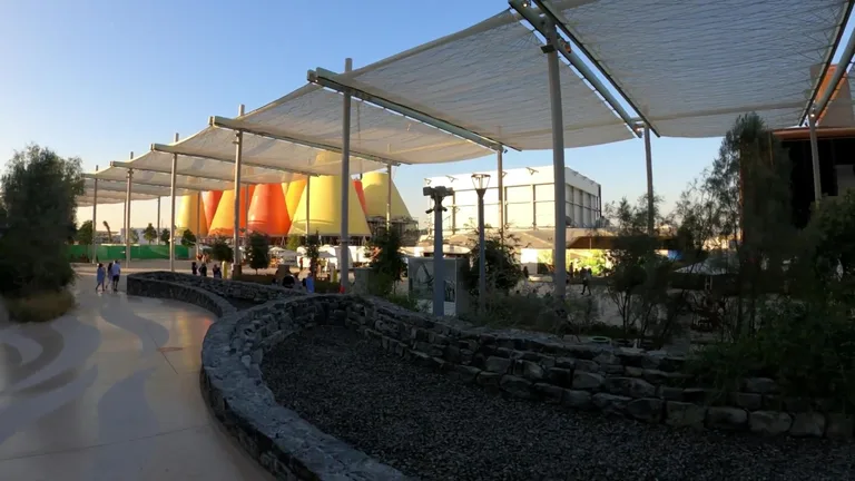 Large atrium with thousands of iridescent butterfly shapes suspended from the ceiling.